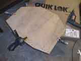 Template clamped to plate for hole cutting